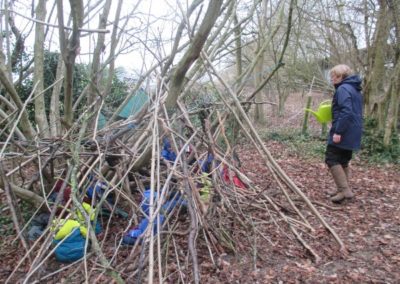 Reception children build a den at forest school